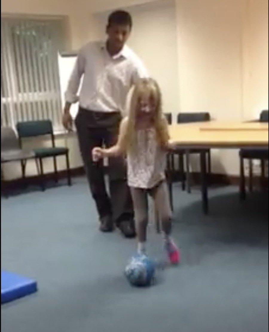Working with a young patient during a physiotherapy session, UK